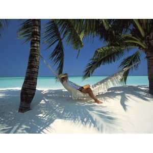  Man Relaxing on a Beachside Hammock, Maldives, Indian 