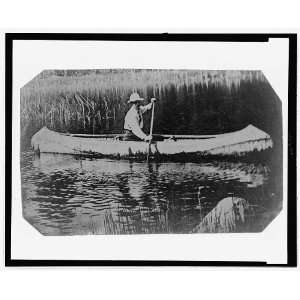    Man paddling a canoe,1890 1910,Tintype,wearing hat