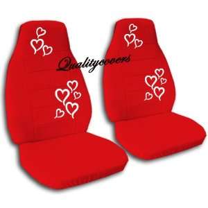  2 red car seat covers with white hearts for a 2002 Ford 