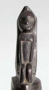 OLD EBONY CARVING WITHPIGS IN COITUS AND SPIRIT FIGURE AT TAIL END.